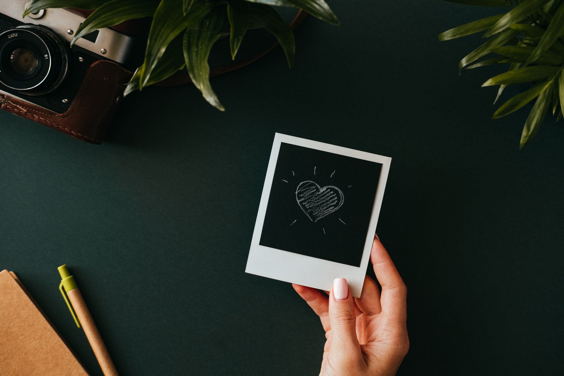 Female Hand Holds Instant Film Photo